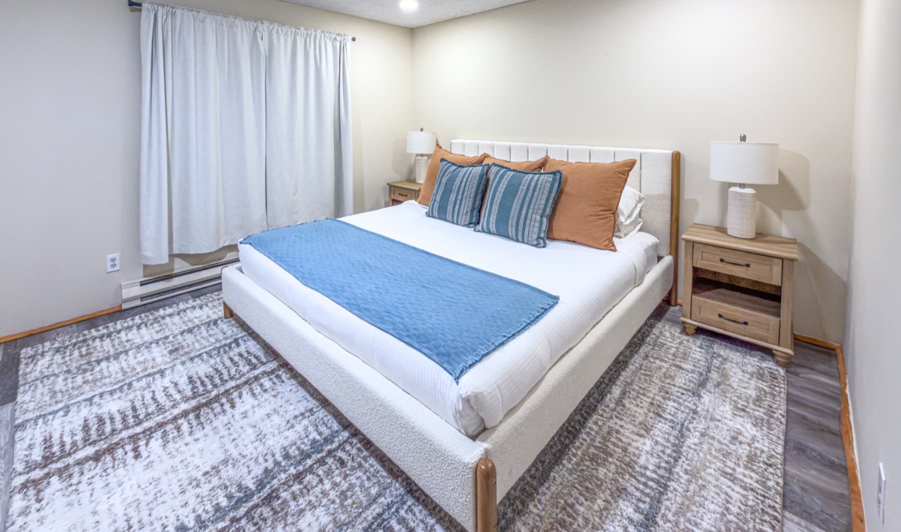 Upstairs king bedroom — clean, modern, forest views
